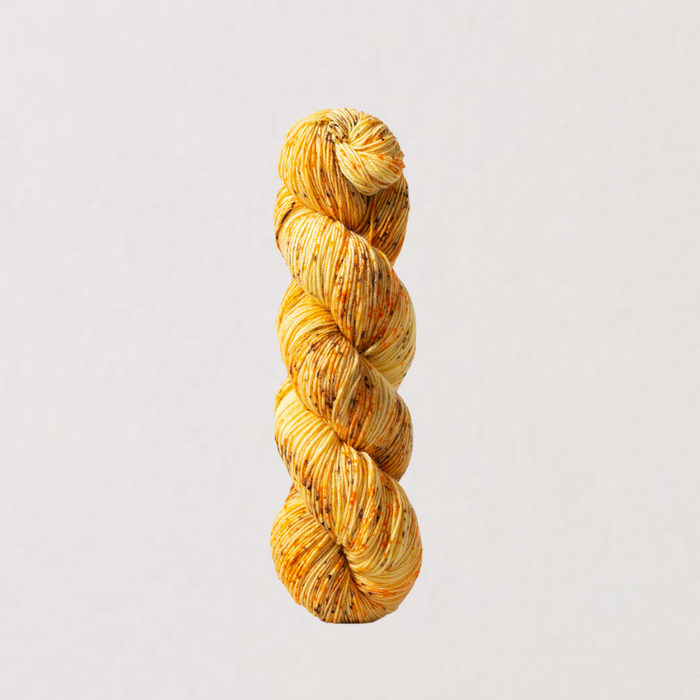 Braided yellow yarn on a light gray background