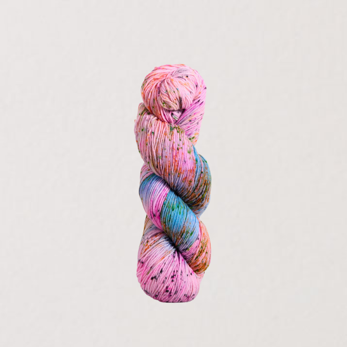 Multicolored skein of yarn on a light gray background