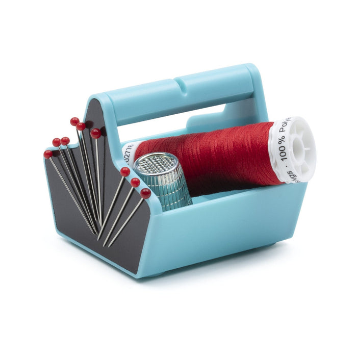 Blue prym caddy with red thread, pins, and a needle case on a white background