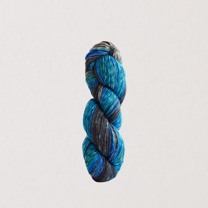 Braided skein of blue and gray yarn on a light gray background