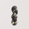Skein of multicolored yarn on a light gray background