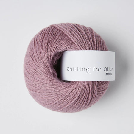 Pink skein of yarn with a label on a white background