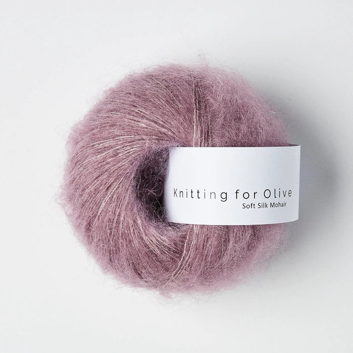 Ball of pink yarn with a label on a white background