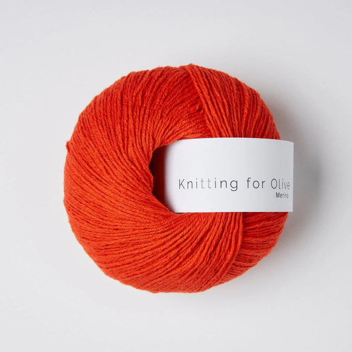 Ball of red yarn with a label on a white background