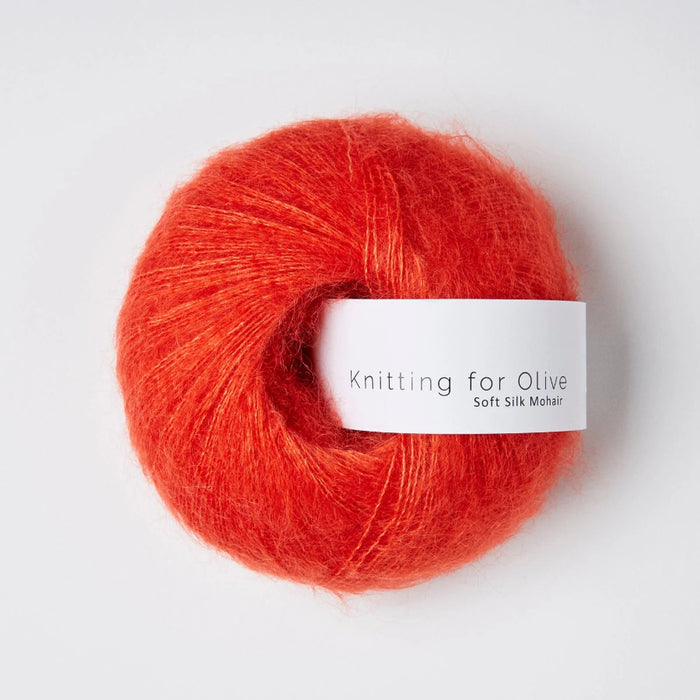 Ball of red yarn with a 'Knitting for Olive' label on a white background