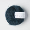 Blue skein of yarn with 'Knitting for Olive' label on a white background