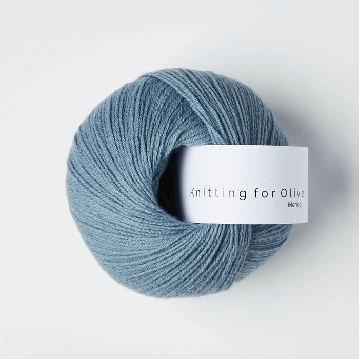 Blue skein of yarn with a label on a white background