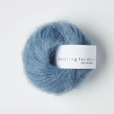Blue skein of yarn with a label on a white background