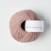 Ball of pink yarn with 'Knitting for Olive' label on a white background