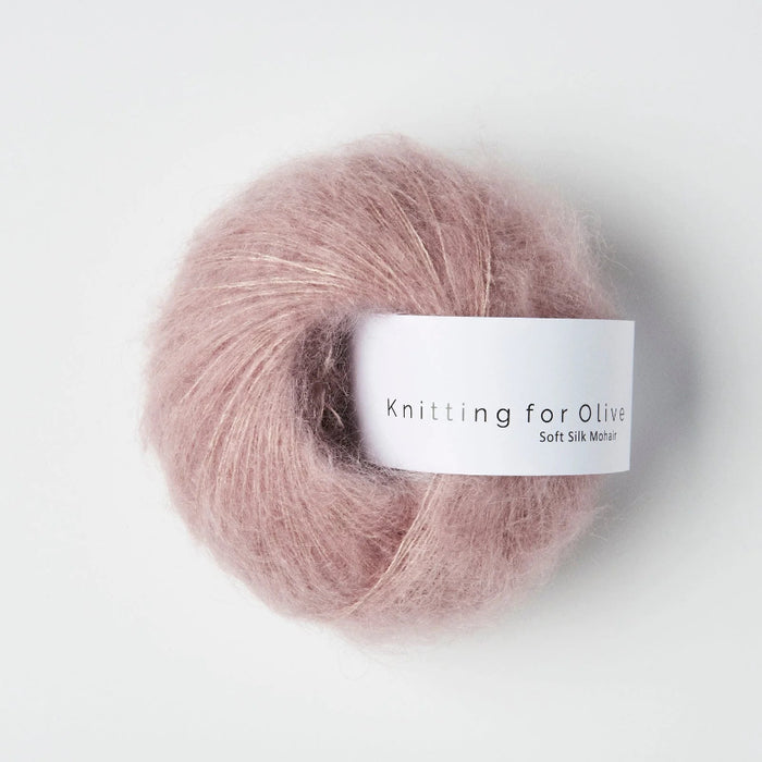 Ball of pink yarn with a label on a white background