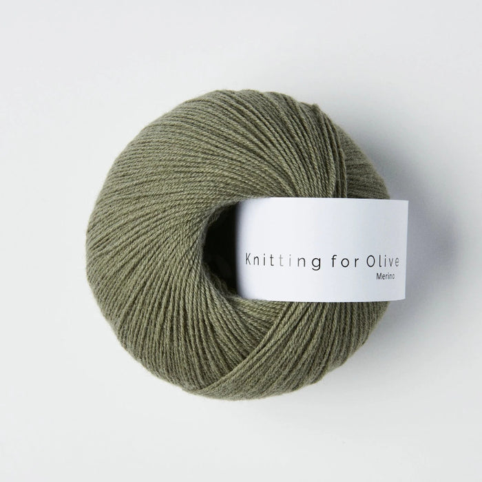Green skein of yarn with a label on a white background