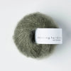 Ball of yarn with 'Knitting for Olive' label on a white background