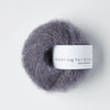 Gray skein of yarn with a 'Knitting for Olive' label on a white background