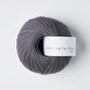 Gray skein of yarn with a label on a white background