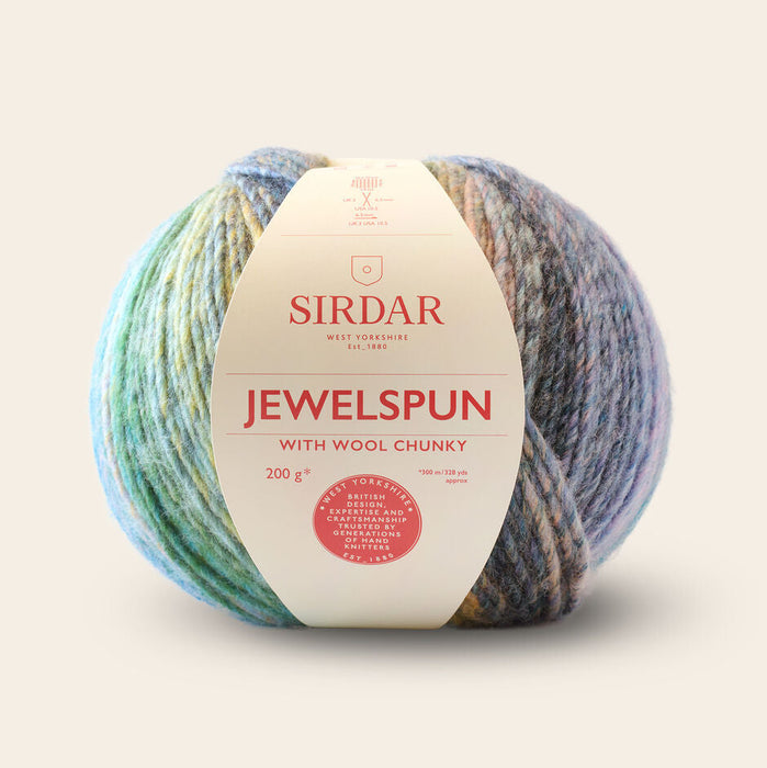 Multicolored ball of yarn with a Sirdar label on a beige background
