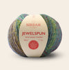 Multicolored ball of yarn with a Sirdar label on a beige background