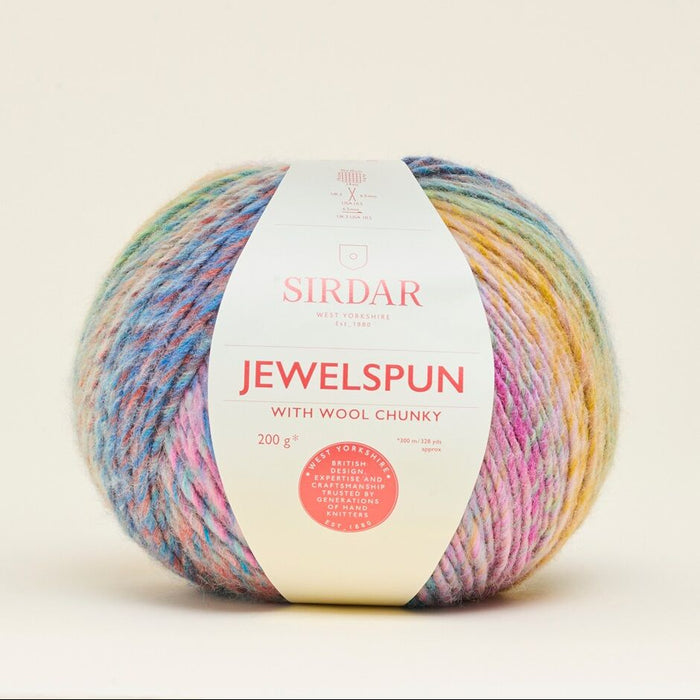 Multicolored ball of yarn with a Sirdar label on a beige background