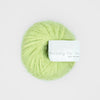 Light green skein of yarn with a label on a white background