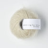 Ball of yarn with 'Knitting for Olive' label on a white background
