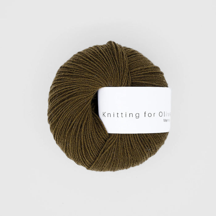 Ball of brown yarn with a 'Knitting for Olive' label on a white background