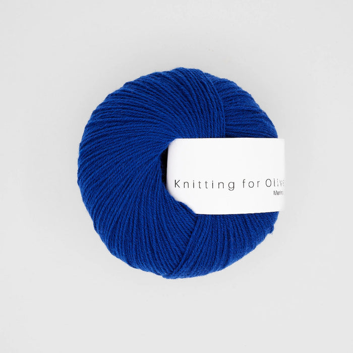 Blue yarn ball with 'Knitting for Olive' label on a white background
