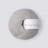 Gray skein of yarn with 'Knitting for Olive' label on a white background