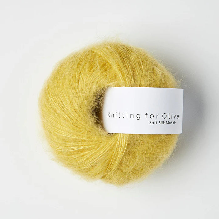 Ball of yellow yarn with 'Knitting for Olive' label on a white background