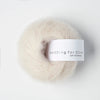 Ball of yarn with 'Knitting for Olive' label on a white background