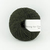 Ball of green yarn with a label on a white background