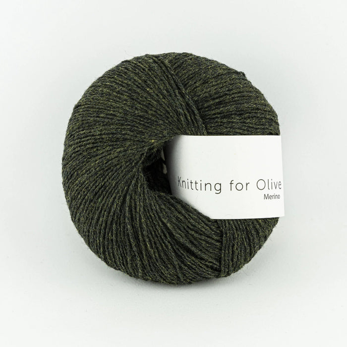 Ball of green yarn with a label on a white background