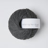 Gray skein of yarn with 'Knitting for Olive' label on a light gray background