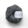 Ball of gray yarn with a label on a white background