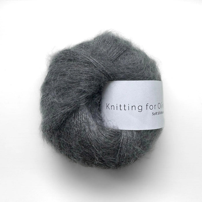 Ball of gray yarn with a label on a white background
