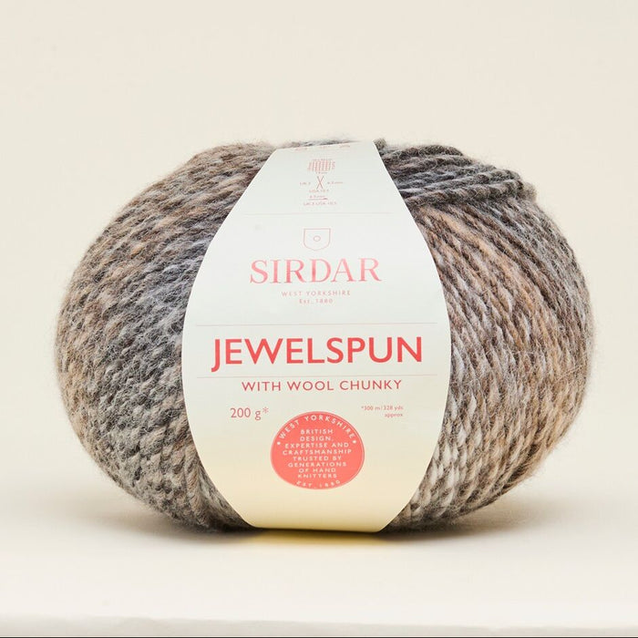 Ball of Sirdar Jewelspun yarn on a beige background