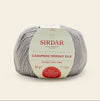 Ball of Sirdar cashmere merino silk yarn on a beige background