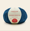 Blue skein of Sirdar Cashmere Merino Silk yarn on a beige background