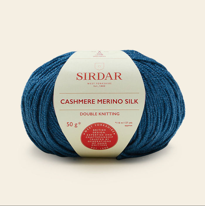 Blue skein of Sirdar Cashmere Merino Silk yarn on a beige background