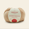 Ball of Sirdar Cashmere Merino Silk yarn on a beige background