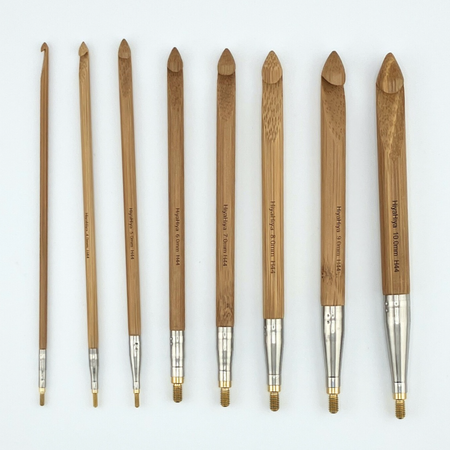 Set of wooden crochet hooks with metal tips on a white background