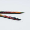 Two wooden knitting needles with a rainbow marbled finish and white printed text reading '7.0mm - US10.