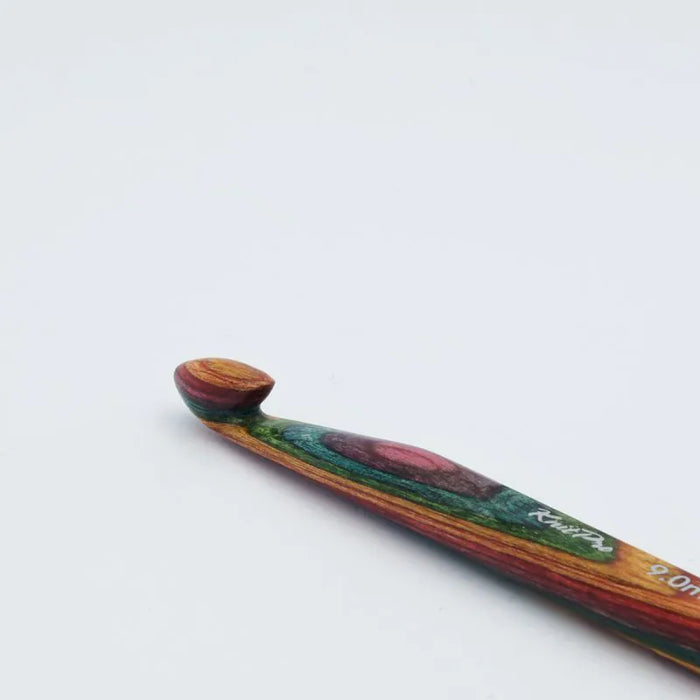 Colorful wooden crochet hook on a white background
