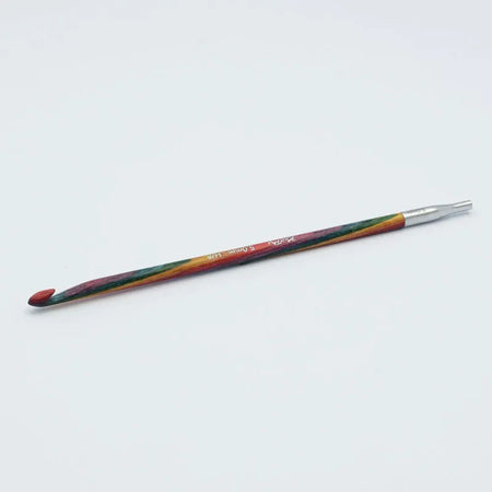 Crochet hook with multicolored handle on a white background