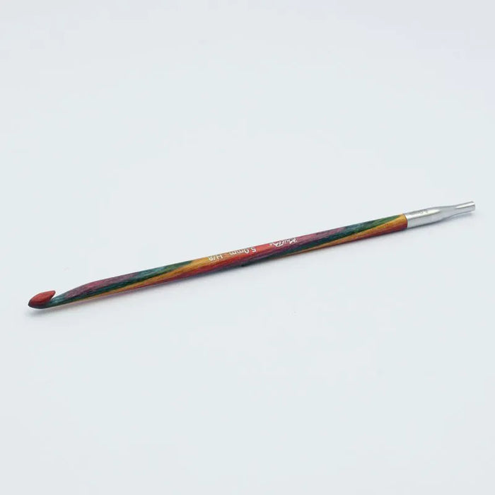 Crochet hook with multicolored handle on a white background