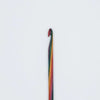 A single crochet hook with a multicolored striped handle, featuring red, orange, yellow, green, and blue stripes, set against a plain white background.